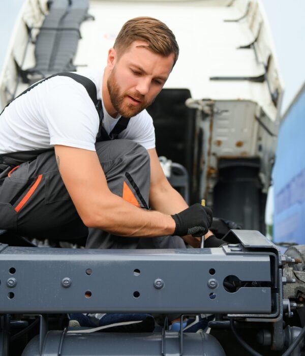 Mechanic repairing the truck in service