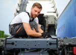 Mechanic repairing the truck in service